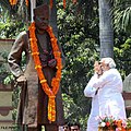 BJP PM candidate Narendra Modi prays in front of a statue of former politician Madan Mohan Malviya during a rally in Varanasi.
