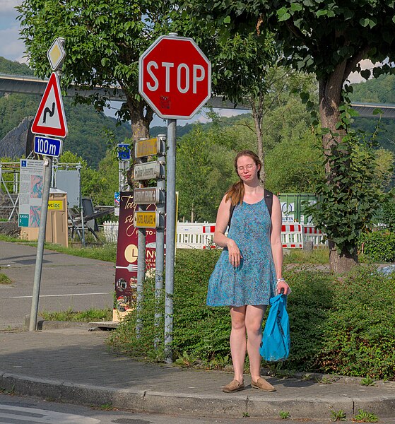 File:A person in blue standing next to a stop sign in Anseremme, Belgium (DSCF7416).jpg