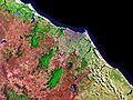 Satellite image showing color contrast between built area (purple), dense vegetation area (green) and semi-arid climate area (red), 1999.