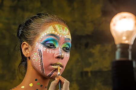 Indian girl during traditional face-painting ritual