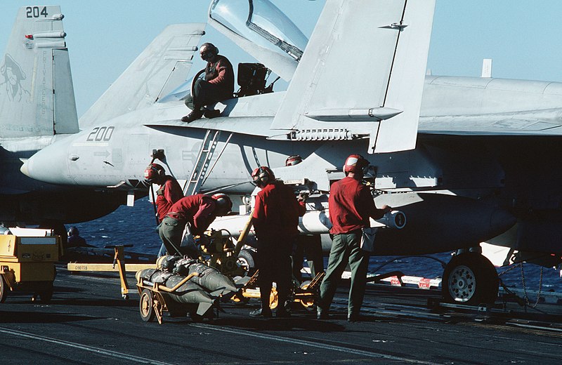 File:Ordnancemen aboard the aircraft carrier USS CORAL SEA (CV 43) prepare to load bombs on an F-A-18A Hornet aircraft - DPLA - 1f2cf68edb91bc142b2fe8592a436da3.jpeg