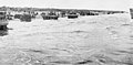 Assault elements of Force U, including DD tanks, were still on the beaches when this photo was taken shortly after H Hour. The amphibious tanks await the blowing of breaches in the sea wall