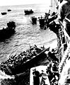 U.S. troops go over the side of a Coast Guard manned combat transport to enter the landing barges at Empress Augusta Bay, Bougainville, as the invasion gets under way. November, 1943.