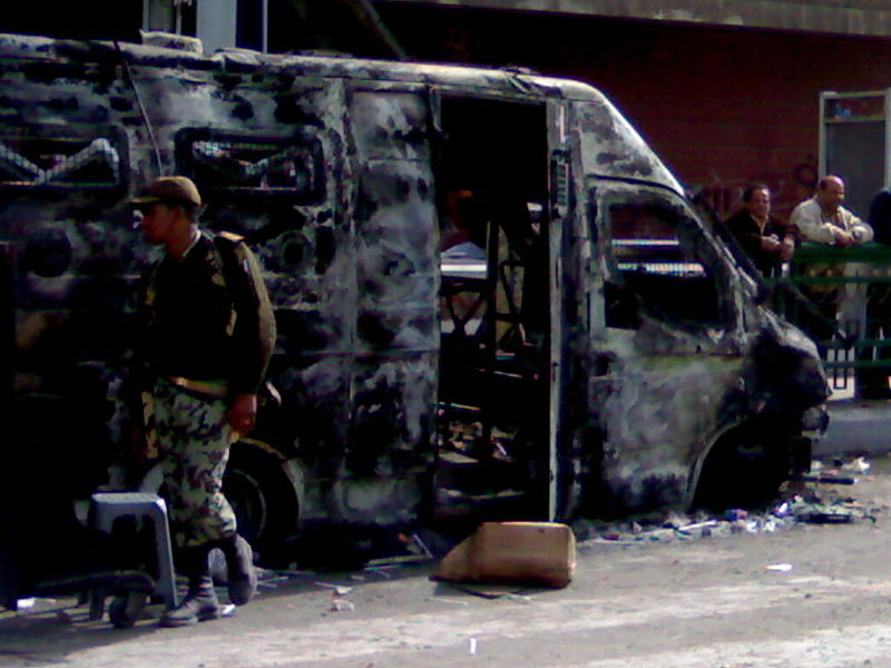 File:Egyptian Army officer with a Police armoured vehicle burnt during the January 25th revolution.jpg