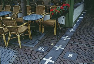 Sidewalk marking Belgium-Netherlands border.