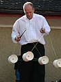 Street artist using four diabolos at same time