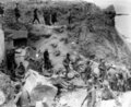 The American flag had been spread out to stop fire of friendly tanks coming from inland. Some German prisoners are being moved in after capture by the relieving forces, Point Du Hoe, 8 June 1944