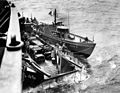 Photo catch from the bridge of a ship. A transporting LCT with jeeps is assisted by a tug boat - June 1944