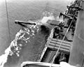 USS Dunlap (DD 384) firing a torpedo from her starboard waist torpedo tubes, during exercises, 3 July 1942.