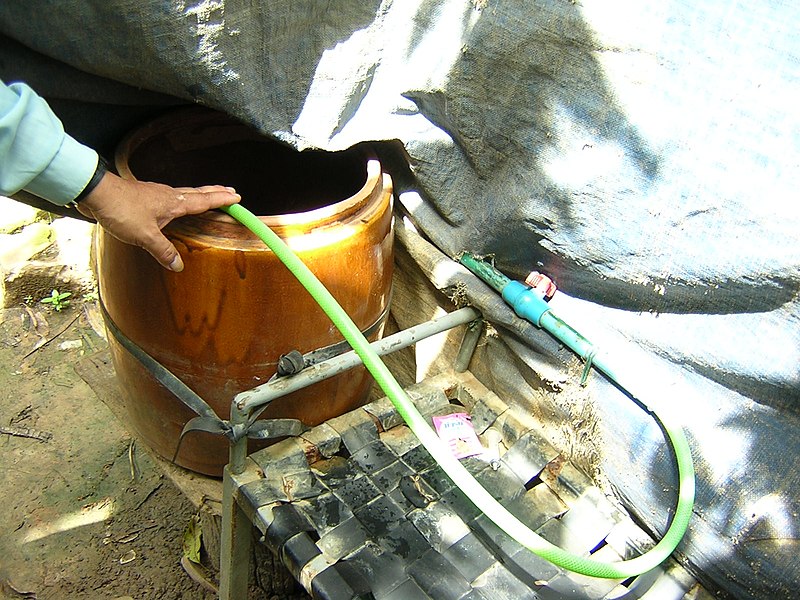 File:Rainwater harvesting tank to bathing bench (Cambodia) (5601381672).jpg