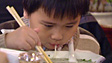 Boy eating expensive noodle soup