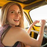 girl smiling behind the wheel