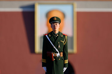 A police officer guarded a Mao Zedong portrait at Tiananmen Square in Beijing.