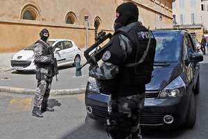 French gendarme special forces unit members secure an entrance of the courthouse during the transfer of the Naples-based Camorra mafia member Antonio Lo Russo in Aix-en-Provence April 16, 2014. Antonio Lo Russo, who was arrested in Nice yesterday by Italian and French police, is a member of the Naples-based Camorra mafia and one of Italy's 100 most-wanted fugitives.