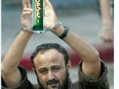 A screenshot of a tweet featuring an image of Marwan Barghouti with a Tortit candy bar.