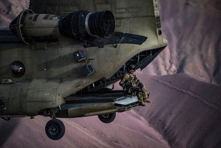 A U.S. Army Task Force Brawler CH-47F Chinook flight engineer sits on the ramp while conducting a training exercise with a Guardian Angel team assigned to the 83rd Expeditionary Rescue Squadron at Bagram Airfield, Afghanistan, March 26, 2018. The Army crews and Air Force Guardian Angel teams conducted the exercise to build teamwork and procedures as they provide joint personnel recovery capability, aiding in the delivery of decisive airpower for U.S. Central Command.