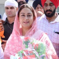 Minister of Food Processing Industries Harsimrat Kaur Badal holds flowers after paying her respects at the Golden Temple in Amritsar on Friday.