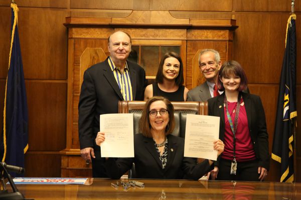 Oregon's Democratic Gov. Kate Brown signs a bill that adds the state to the National Popular Vote compact.