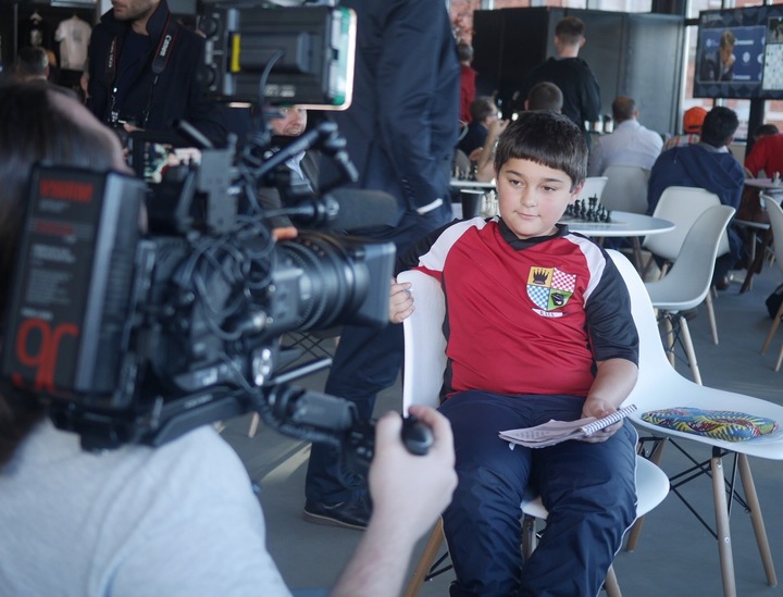A young chess fan is interviewed by Russian media