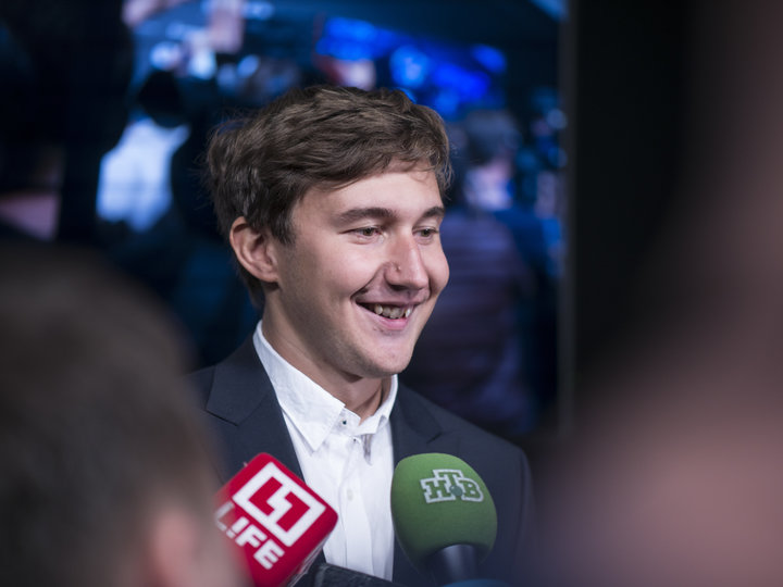 A cheerful Sergey Karjakin is interviewed after the first game