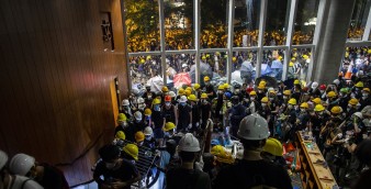 Radical protesters break in to the Legco complex on Monday night. Apart from those who rampaged through the building, there were many other young protesters who gathered outside. Photo: Bloomberg