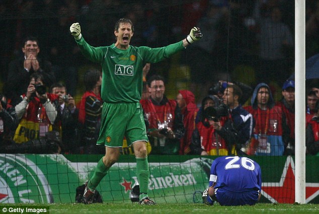 United goalkeeper Edwin van der Saar celebrates in the Moscow rain as Terry crumples to the ground