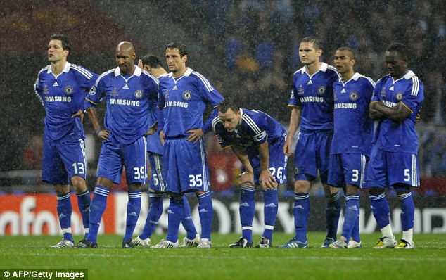 Terry stands back on the half-way line with his team-mates to watch the rest of the penalties in Moscow