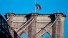 The US flag is seen at half-mast on the Brooklyn Bridge in New York on April 11th. Photograph: Johannes Eisele/AFP via Getty Images