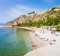 People sunbathing by the beach in Nafplio.