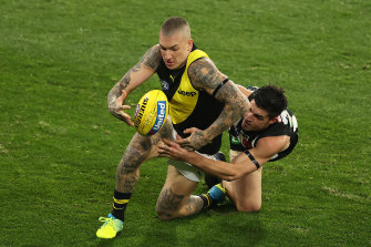 Richmond's Dustin Martin is challenged by Brayden Maynard of the Magpies.