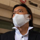 Barrister Laurence Lau, representing Tong Ying-kit (not pictured) who is accused of deliberately driving his motorcycle into a group of police officers, speaks to the media outside court in Kowloon, Hong Kong.