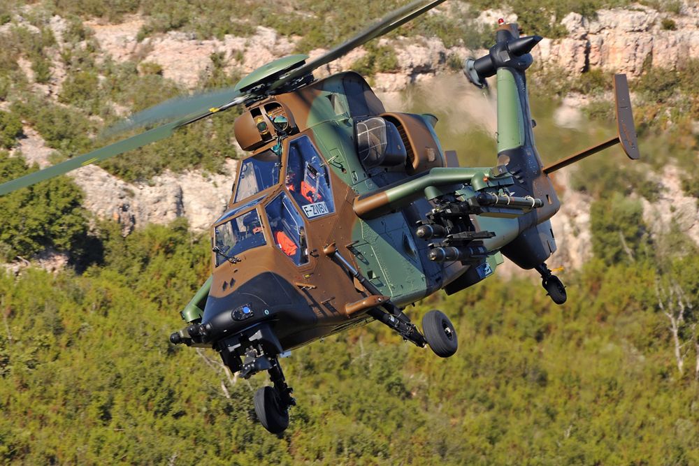 An in-flight Airbus Tiger HAD military helicopter with side-mounted weapon systems. 