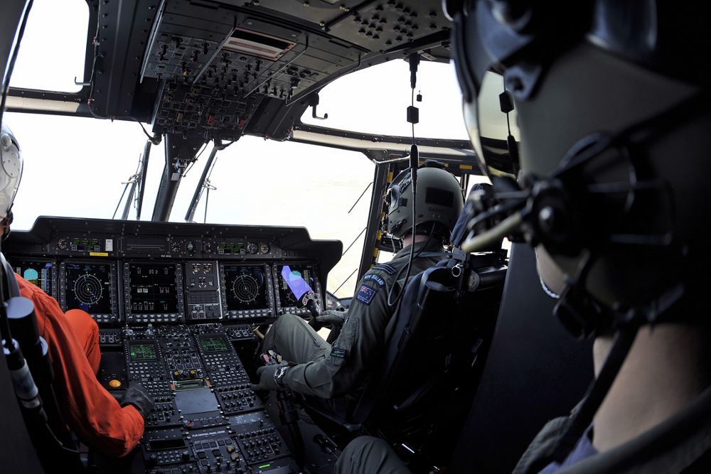 Photo of the flight crew and controls inside an NH90 helicopter’s cockpit. 