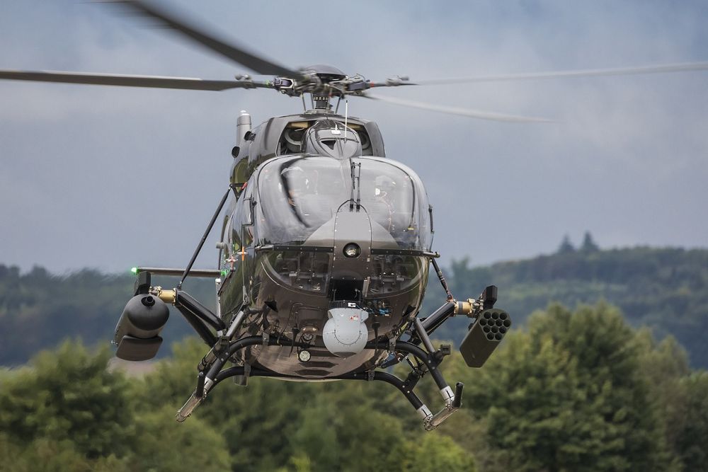 Head-on photo of an in-flight Airbus H145M military helicopter. 