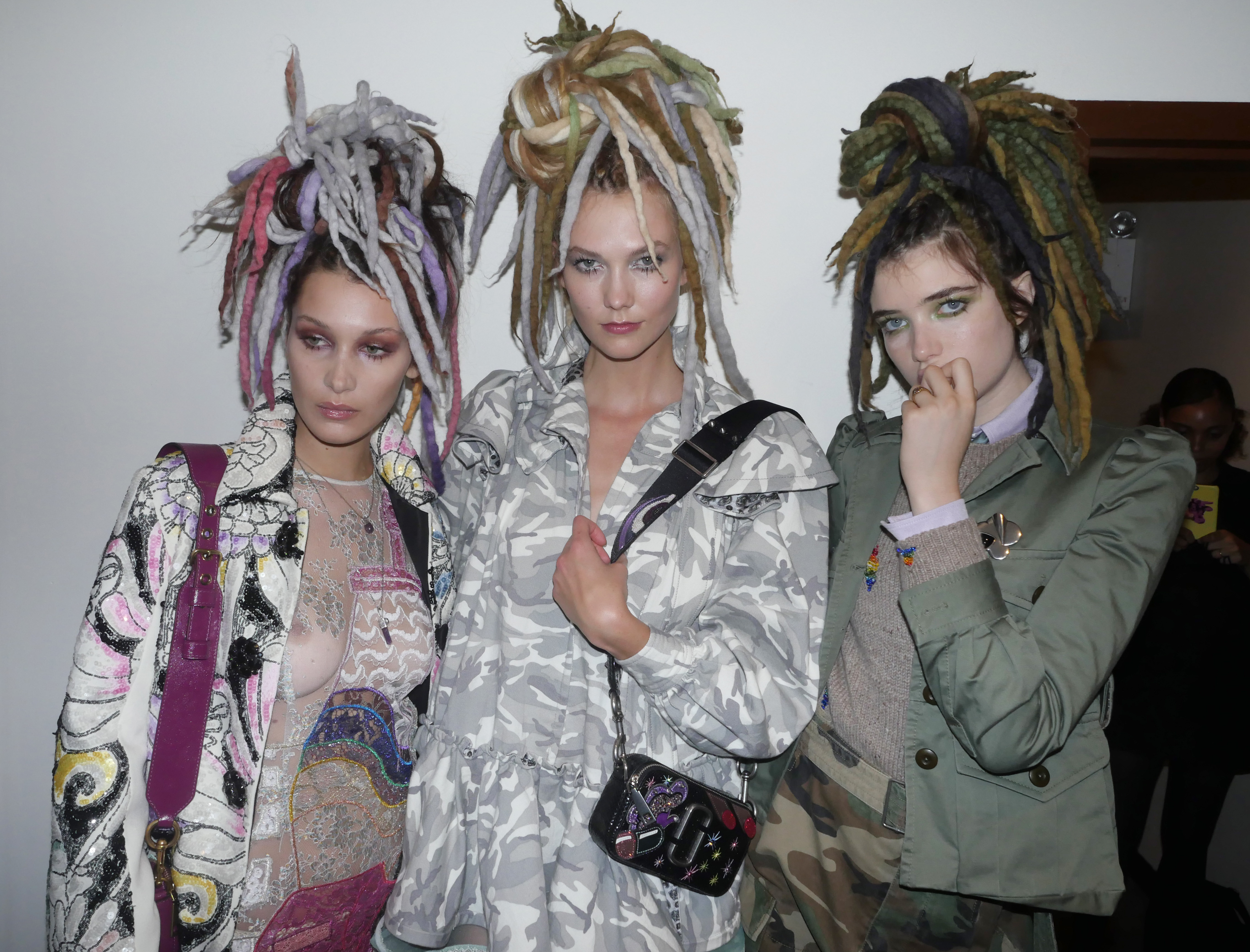 Bella Hadid, Karlie Kloss and Grace Hartzel backstage at the Marc Jacobs spring 2017 runway show in dreadlock wigs, which Jacobs apologized for after the show.