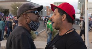 A supporter of US president Donald Trump (right) speaks with a supporter of president-elect Joe Biden at a “Stop the Steal” protest  in Phoenix, Arizona, on Saturday. Photograph: Bloomberg