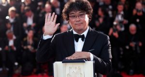  South Korean director Bong Joon-ho poses with his Palme dOr at the Cannes Film Festival, in Cannes, France. Photograph: Ian Langsdon/EPA