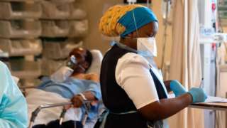 Medic writing notes at hospital near Cape Town.