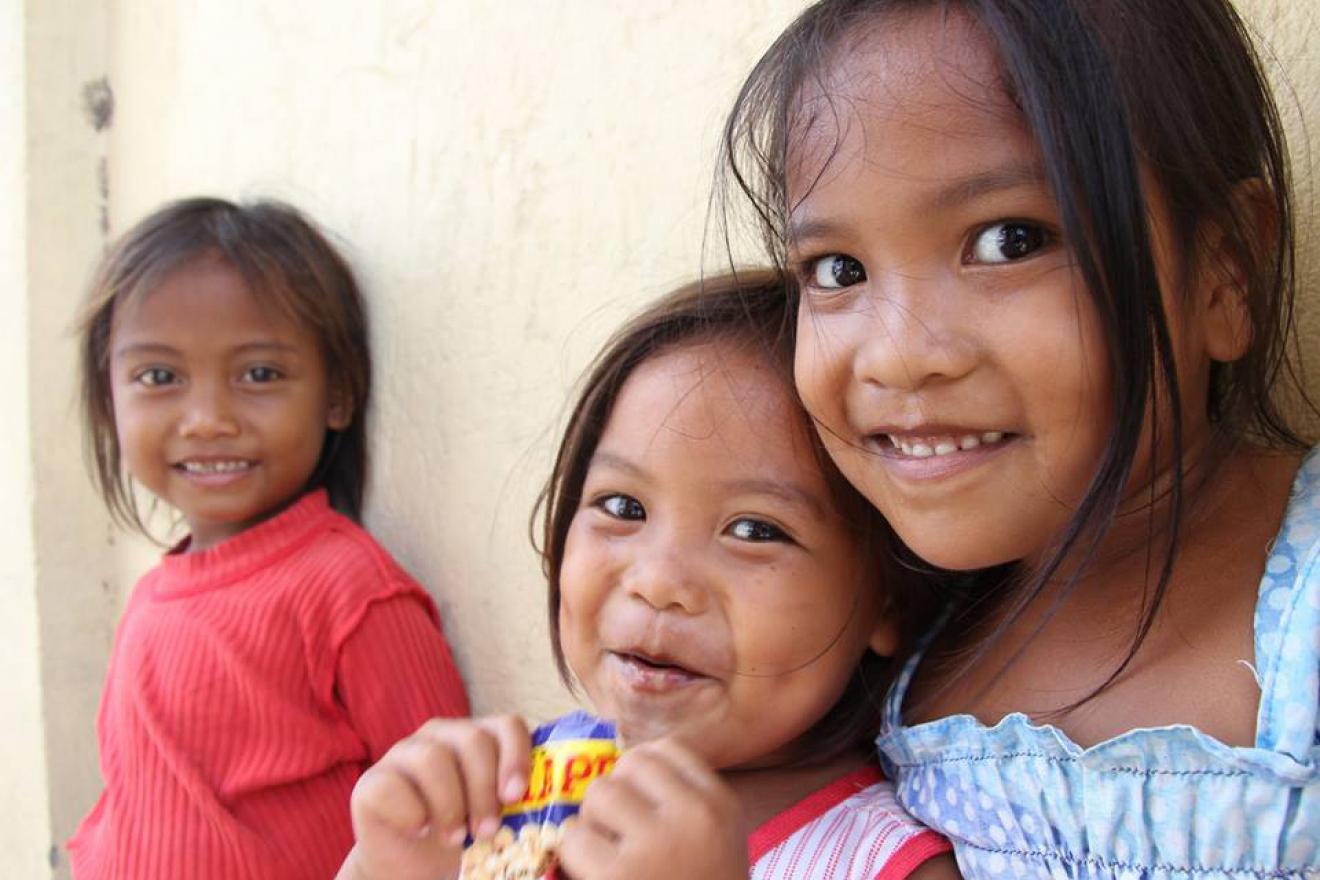 young children smiling at camera