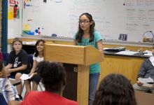 Middle school student speaks in front of her class
