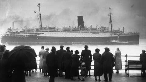 Crowds gather to see the 16,243 ton Cunard cruise liner Lancastria, grounded in the River Mersey off Egremont in 1936