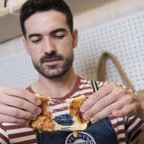 Alex Grenouiller with a grilled cheese sandwich at Penny’s Cheese Shop.