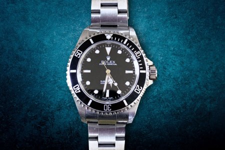 A Rolex Submariner on a blue background