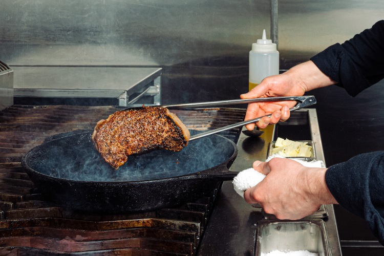 steak over a cast-iron skillet.