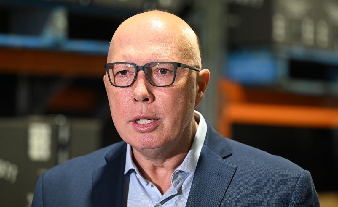 Image of Peter Dutton, wearing glasses and a suit with no tie.