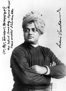 Black and white image of Vivekananda, facing left with his arms folded and wearing a turban