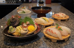 Various types of sushi with green shiso leaves