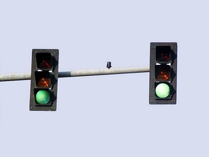 Traffic signals installed in Shelton, Washington, seen off-axis from the intended viewing area (top) and from the signal's intended viewing area (bottom).From off-axis, these signals appear to be "off" or invisible to adjacent lanes of traffic during the daytime. Only a faint glow can be seen when viewed at night.