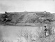 A monochrome photograph of the North Saskatchewn River with Fort Edmonton in the background