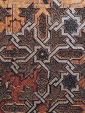 Almoravid Minbar in Marrakesh, commissioned in 1137, now at the Badi Palace Museum. Its surfaces are decorated with a mix of geometric and arabesque motifs in marquetry, inlay, and carving.
